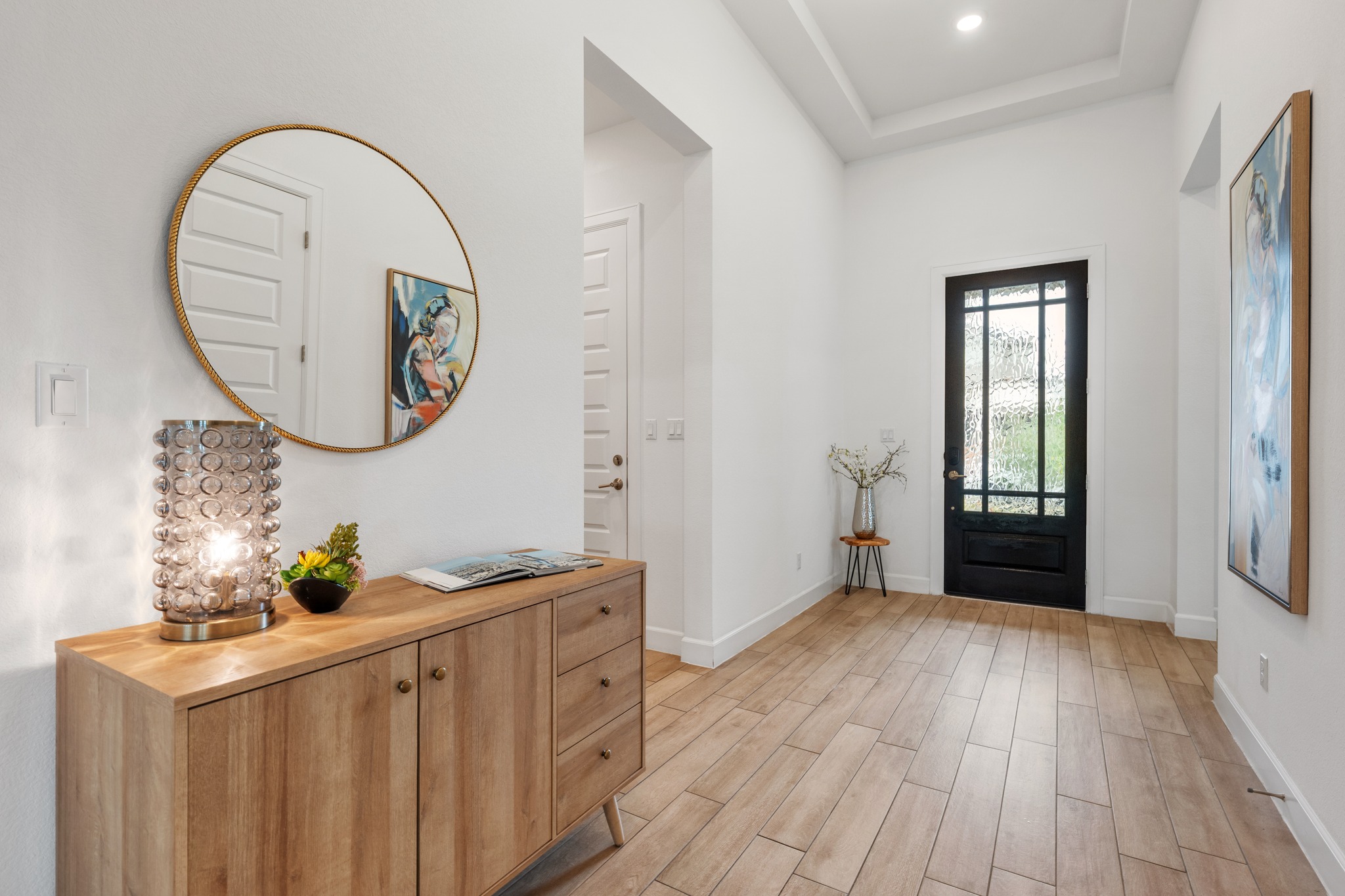 606 Bonfisk Bend Austin, TX 78738 - Photo 4 of 40 a view of a room with wooden floor and entryway