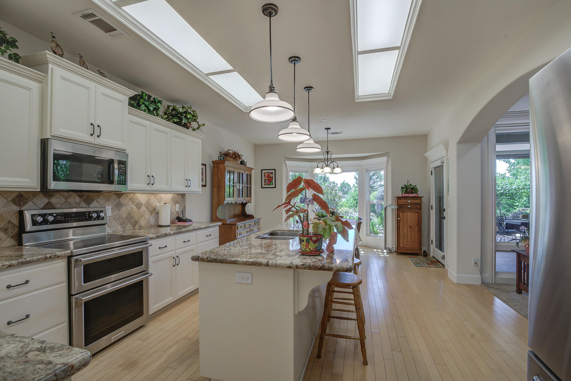 2000 Princeton Way Redding, CA 96003 - Photo 14 of 60 a kitchen with stainless steel appliances granite countertop a sink a stove and a wooden floors