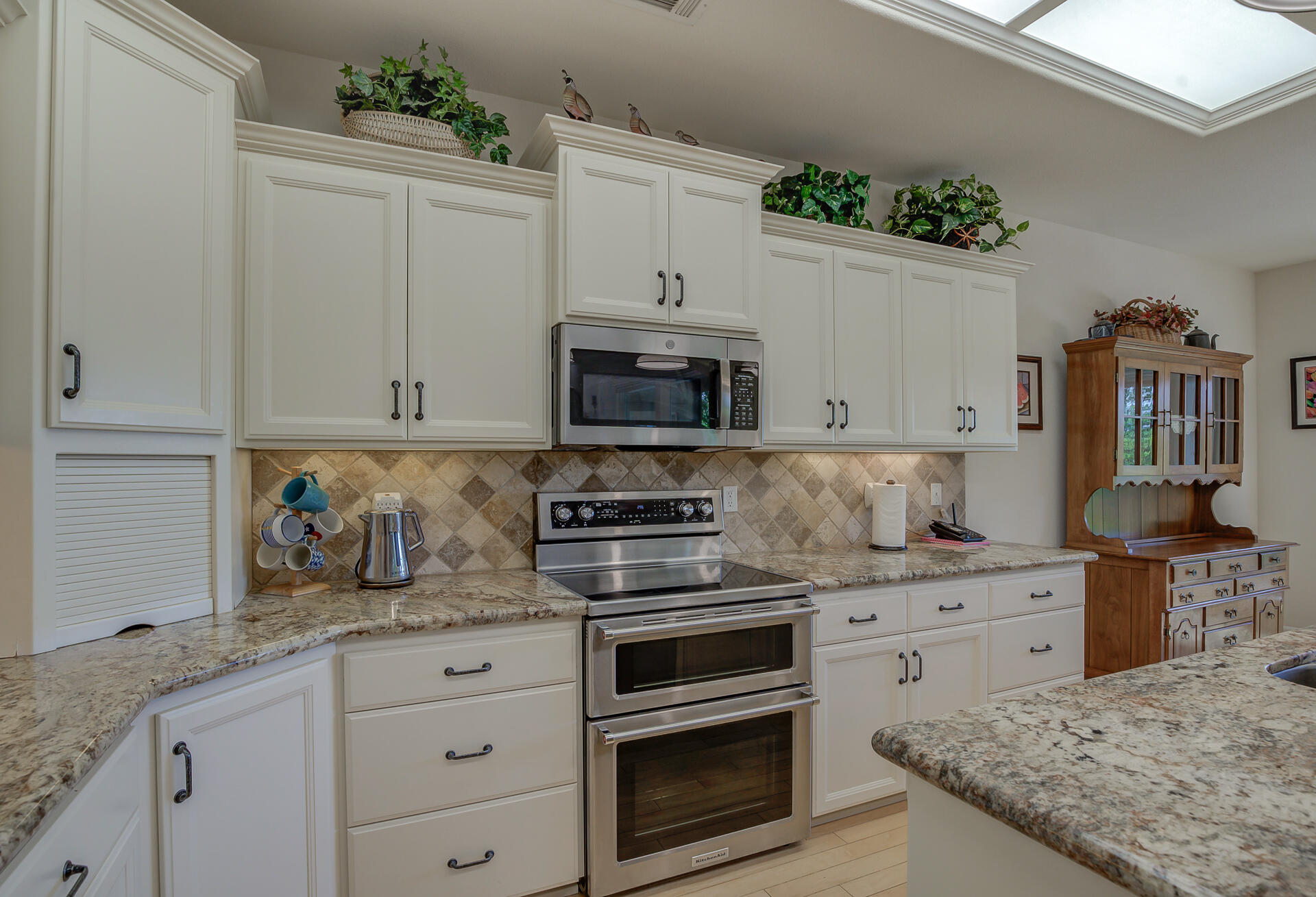 2000 Princeton Way Redding, CA 96003 - Photo 15 of 60 a kitchen with granite countertop a stove sink and cabinets