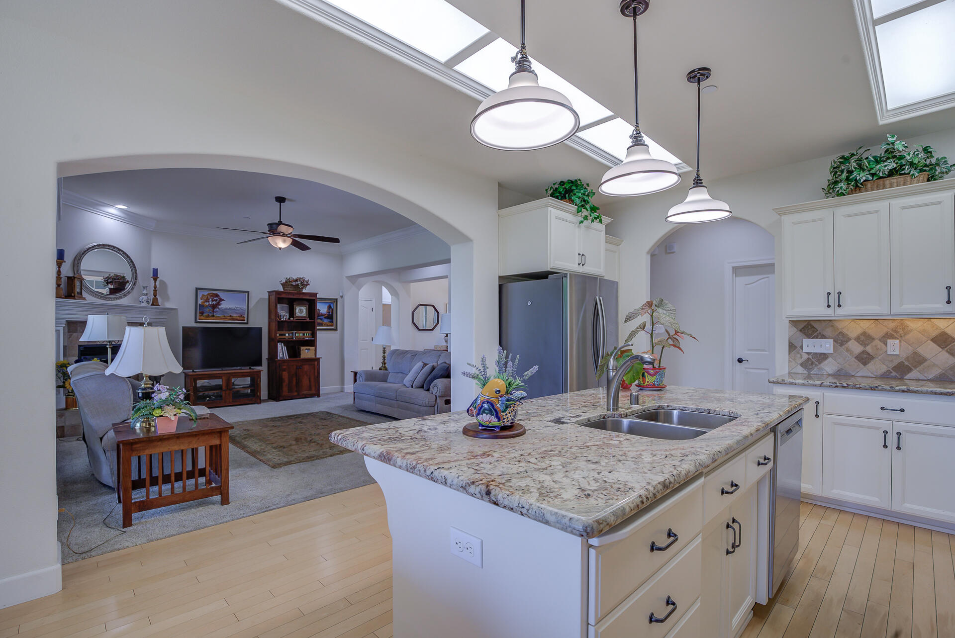 2000 Princeton Way Redding, CA 96003 - Photo 21 of 60 a kitchen with kitchen island granite countertop a stove a sink a dining table and chairs with wooden floor