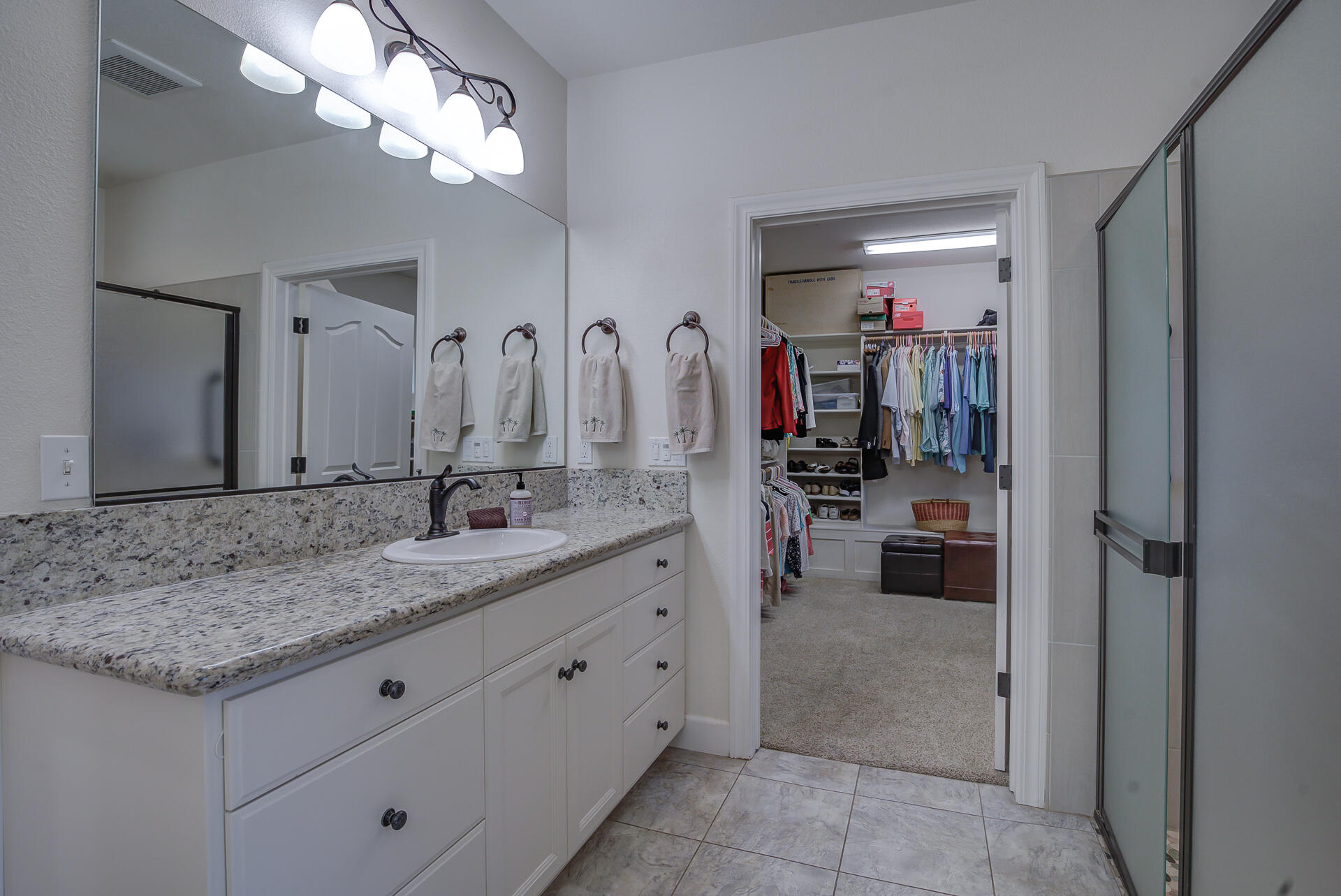 2000 Princeton Way Redding, CA 96003 - Photo 30 of 60 a bathroom with a granite countertop sink a light fixture and a mirror