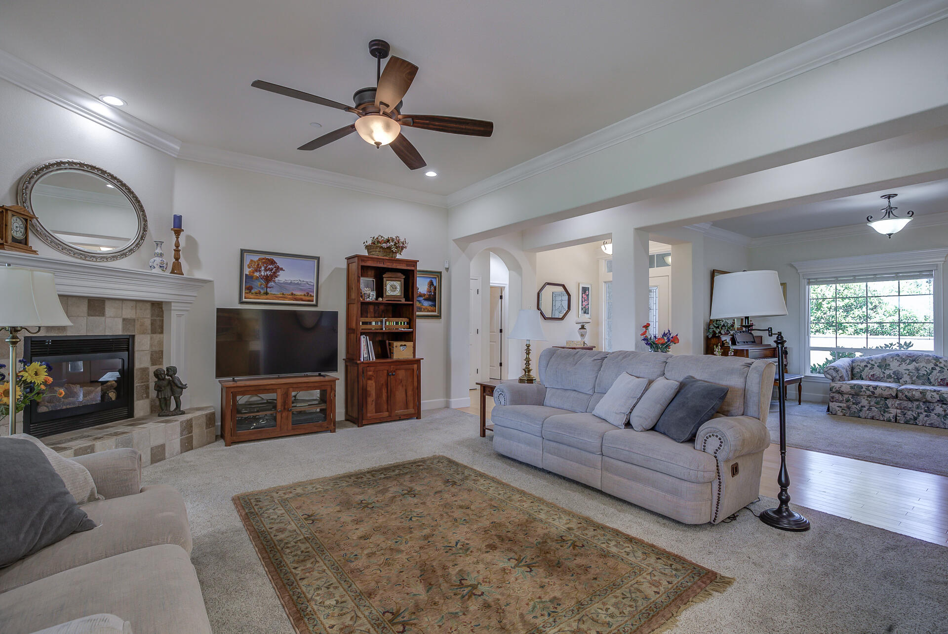 2000 Princeton Way Redding, CA 96003 - Photo 3 of 60 a living room with furniture a fireplace and a flat screen tv