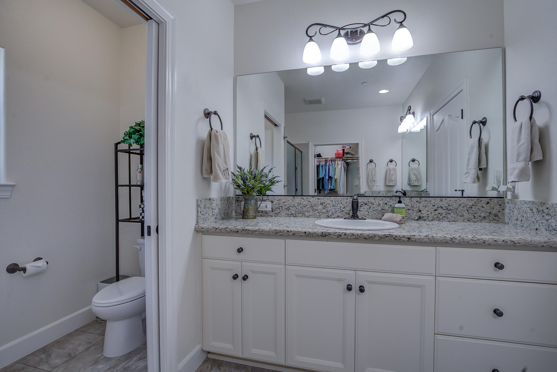 2000 Princeton Way Redding, CA 96003 - Photo 33 of 60 a bathroom with a granite countertop sink a toilet and a mirror