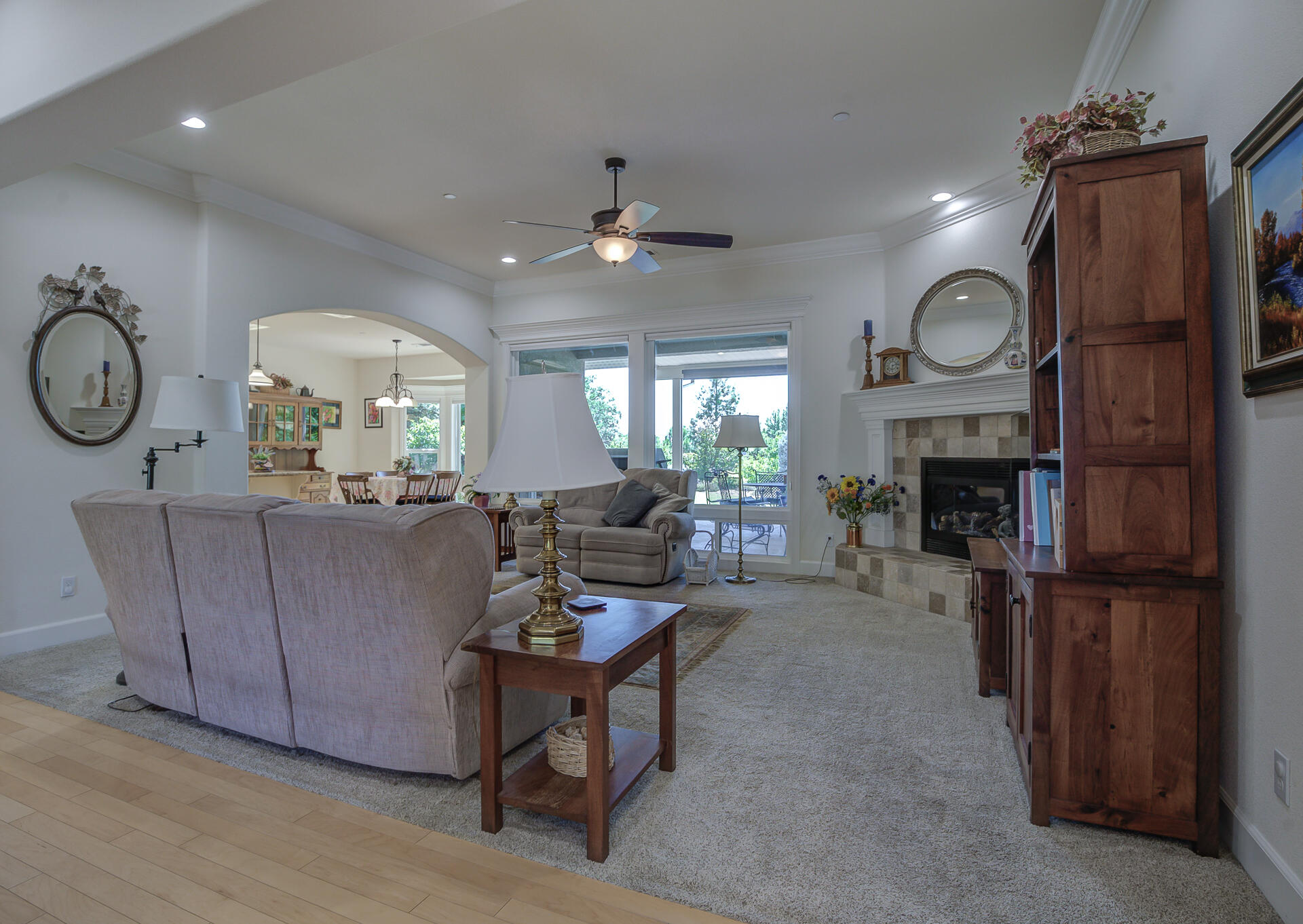 2000 Princeton Way Redding, CA 96003 - Photo 4 of 60 a living room with furniture a fireplace and a chandelier