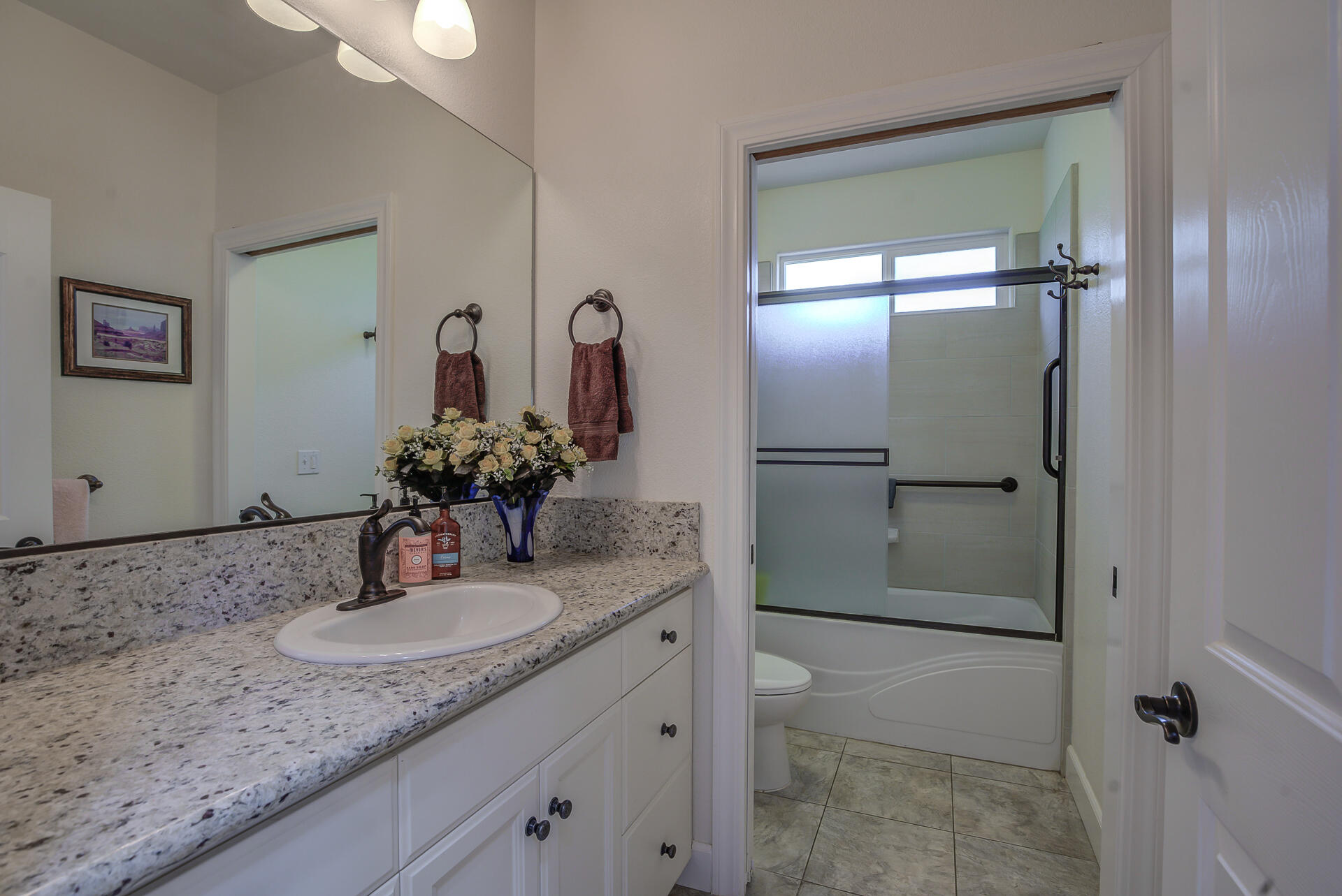 2000 Princeton Way Redding, CA 96003 - Photo 41 of 60 a bathroom with a granite countertop sink and a mirror