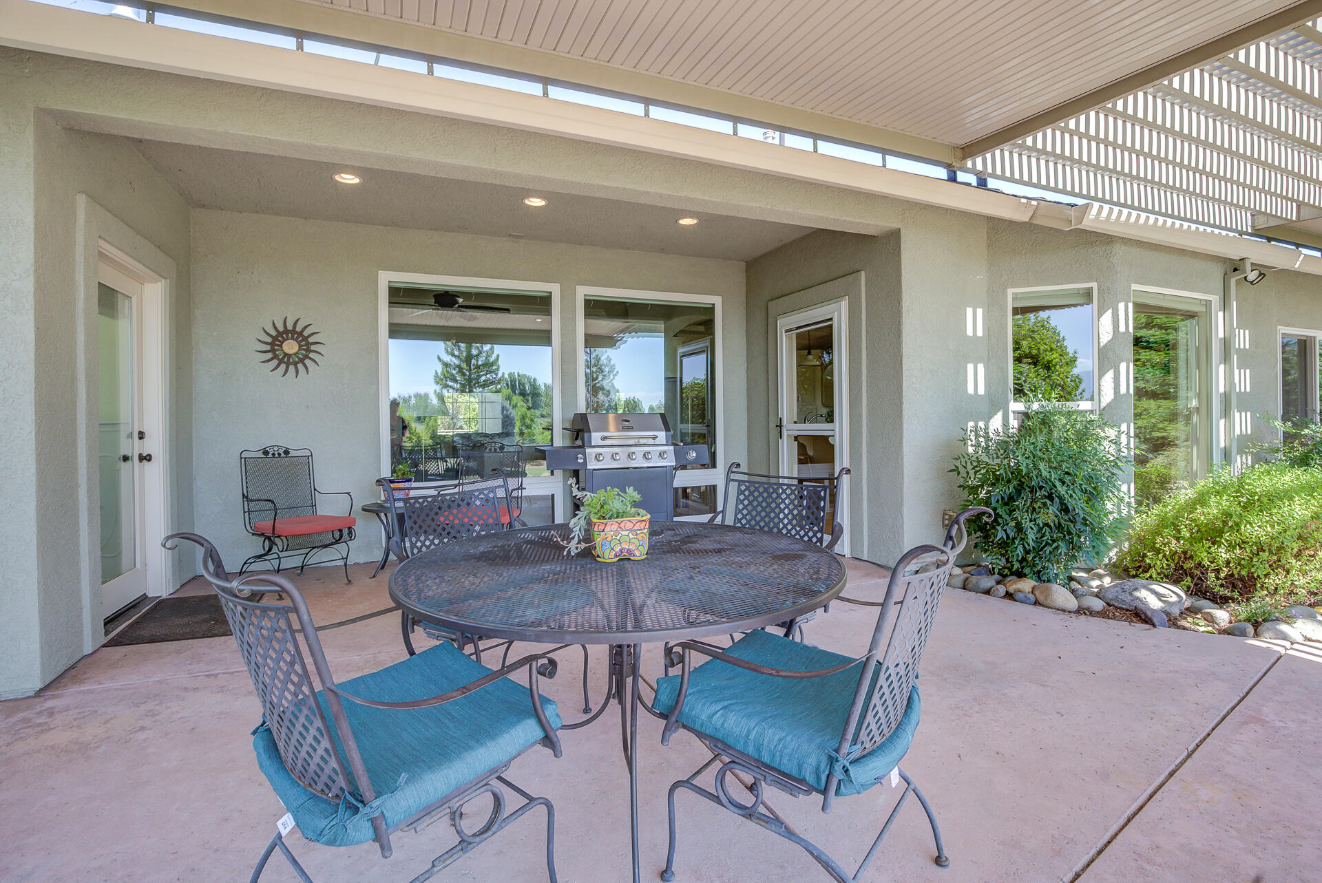 2000 Princeton Way Redding, CA 96003 - Photo 47 of 60 a view of a patio with table and chairs potted plants and floor to ceiling window