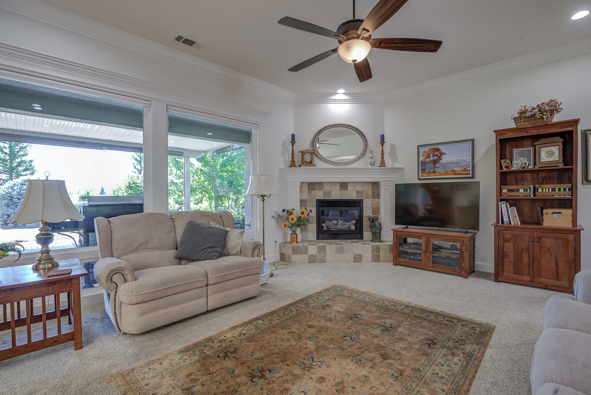 2000 Princeton Way Redding, CA 96003 - Photo 10 of 60 a living room with furniture a flat screen tv and a fireplace