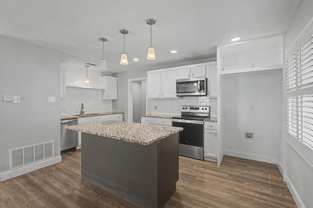 2508 Hillglenn Road Dallas, TX 75228 - Photo 18 of 26 a kitchen with stainless steel appliances granite countertop a sink stove and refrigerator