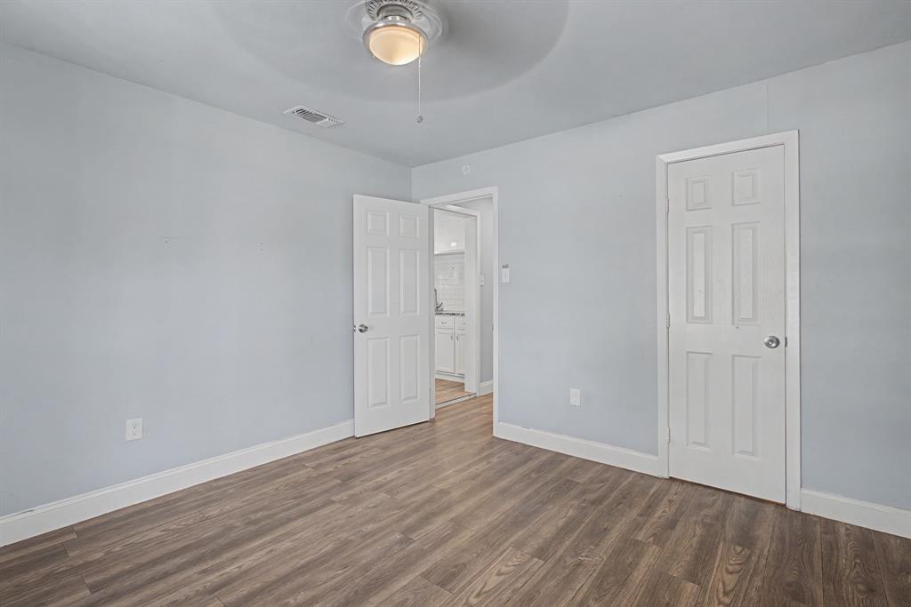 2508 Hillglenn Road Dallas, TX 75228 - Photo 20 of 26 a view of an empty room with wooden floor and window