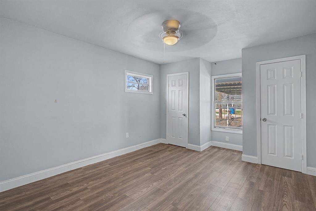 2508 Hillglenn Road Dallas, TX 75228 - Photo 21 of 26 an empty room with wooden floor and window