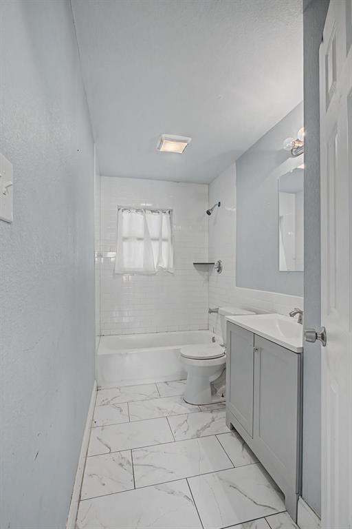2508 Hillglenn Road Dallas, TX 75228 - Photo 26 of 26 a bathroom with a toilet a sink and bathtub