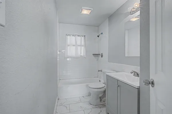 a bathroom with a toilet sink and shower