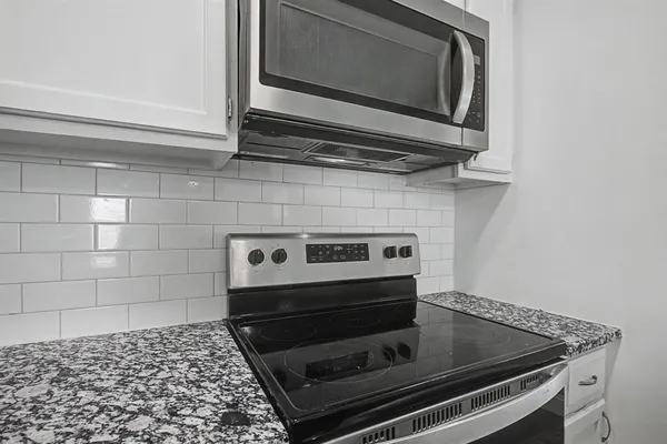 a stove top oven sitting inside of a kitchen
