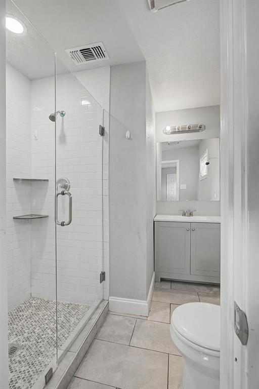 2508 Hillglenn Road Dallas, TX 75228 - Photo 10 of 26 a bathroom with a granite countertop sink a toilet and shower