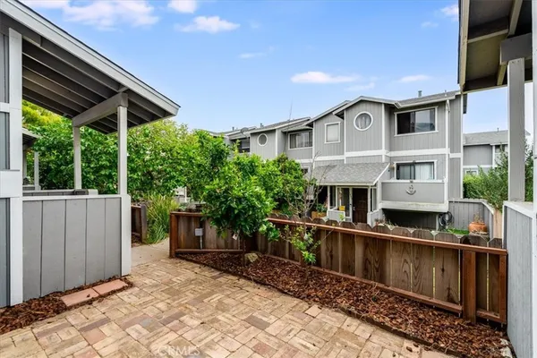a view of a backyard with table and chairs