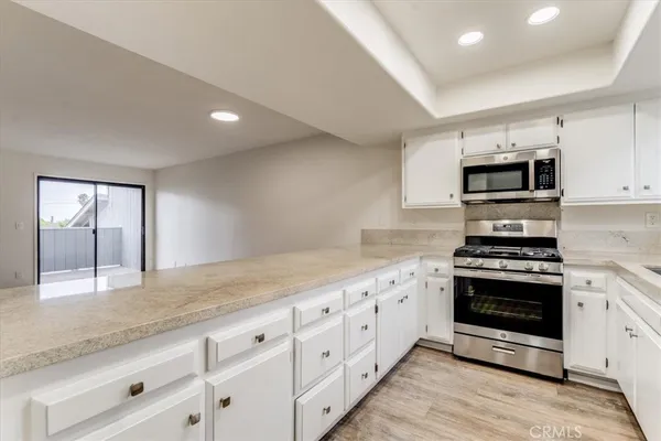 a kitchen with granite countertop a stove and a sink