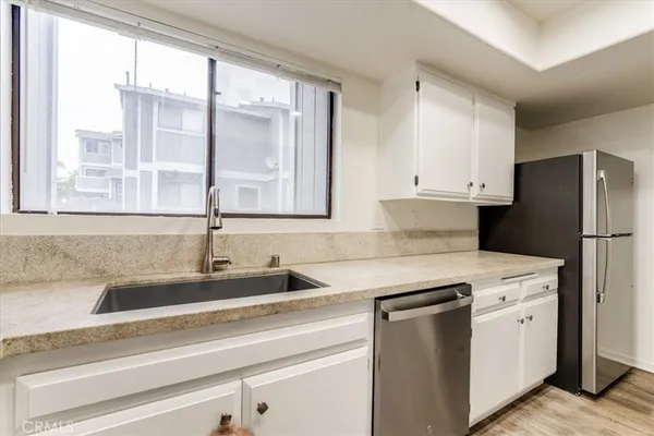 a kitchen with appliances cabinets and a sink
