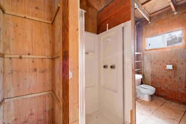 a view of a bathroom with a glass shower door