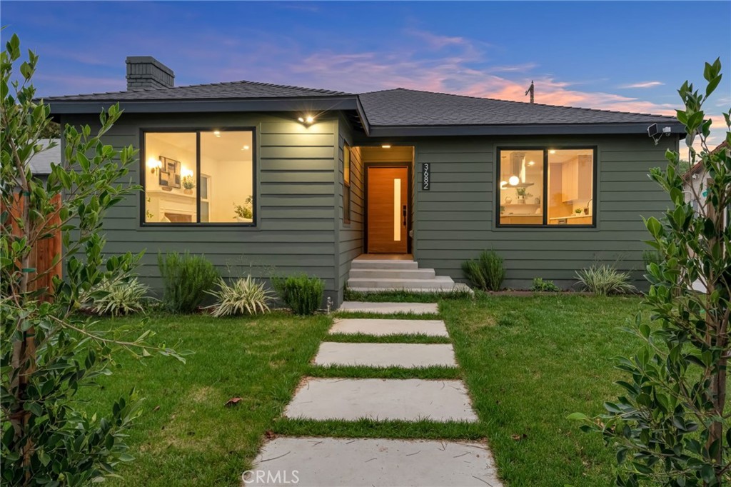3682 Buckingham Road Los Angeles, CA 90016 - Photo 1 of 30 a front view of a house with a yard