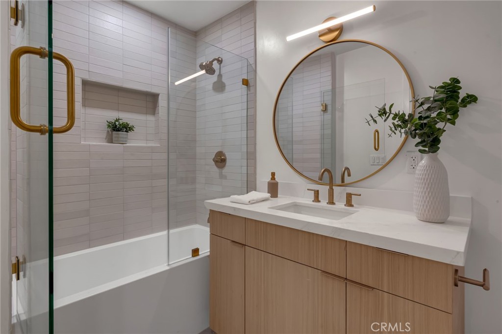 3682 Buckingham Road Los Angeles, CA 90016 - Photo 16 of 30 a bathroom with a sink a potted plant and a mirror