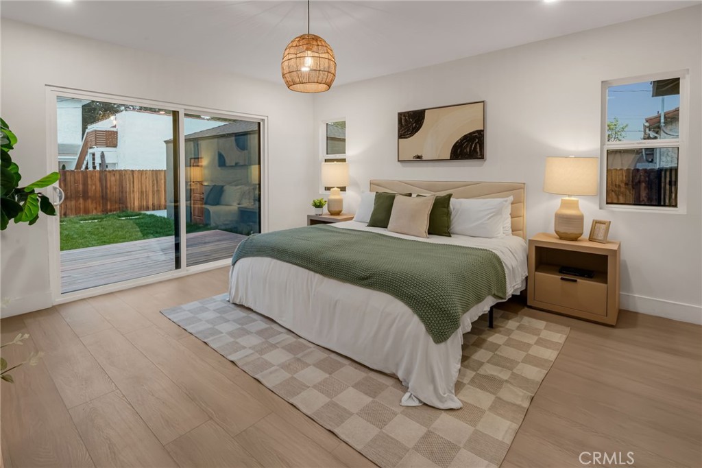3682 Buckingham Road Los Angeles, CA 90016 - Photo 19 of 30 a spacious bedroom with a bed and a large window