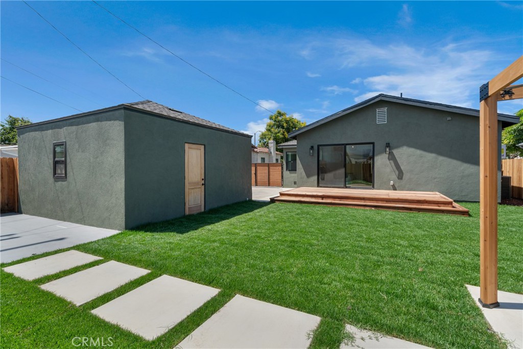 3682 Buckingham Road Los Angeles, CA 90016 - Photo 28 of 30 a house with green field in front of it