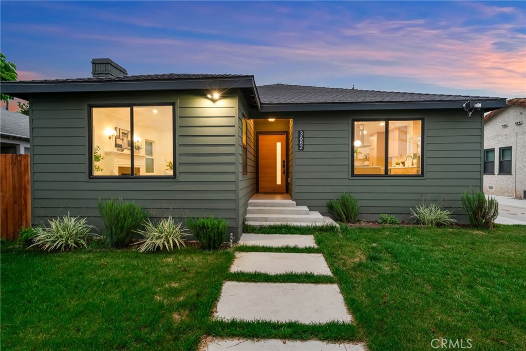 3682 Buckingham Road Los Angeles, CA 90016 - Photo 3 of 30 a front view of a house with a yard