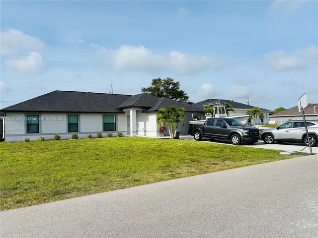 a front view of a house with a garden and deck