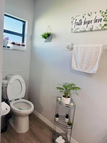 a white toilet sitting next to a white tub