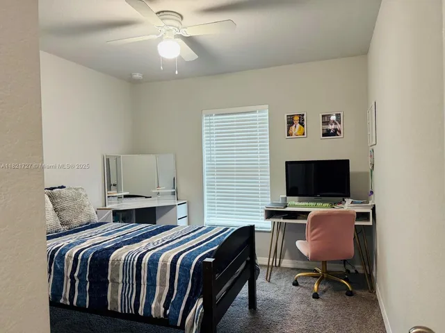 a bedroom with a workspace