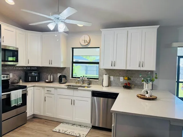 a kitchen with a sink a stove and cabinets