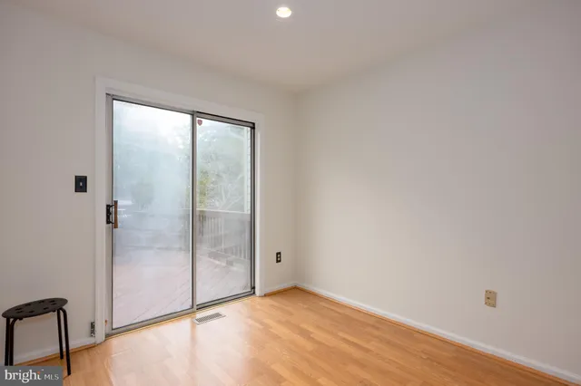 a view of an empty room with glass door