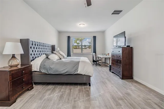 a bathroom with a granite countertop toilet sink and mirror