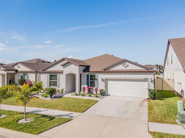 a front view of a house with a yard and garage