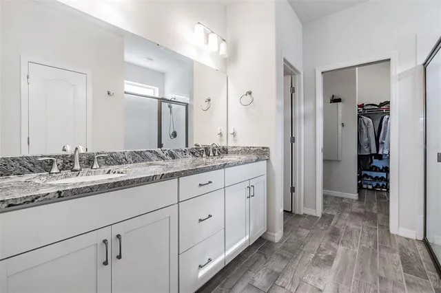 a view of walk in closet with clothes