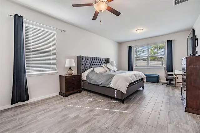 a bedroom with a bed and a window