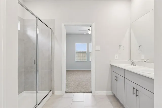 a bathroom with a glass shower door