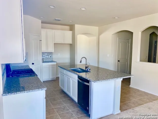 a kitchen with stainless steel appliances granite countertop a sink and cabinets