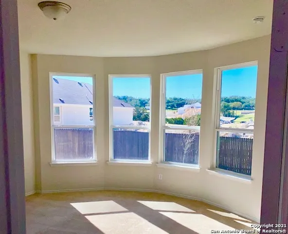 a bathroom with a tub a sink and a large mirror