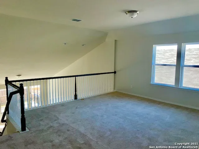 a view of a house with a patio and a yard