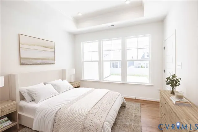 a bedroom with a bed and a large window