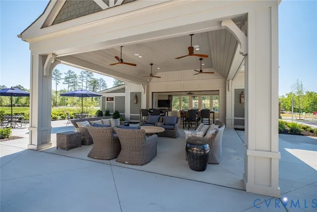 a view of a patio with table and chairs potted plants with wooden floor and fence