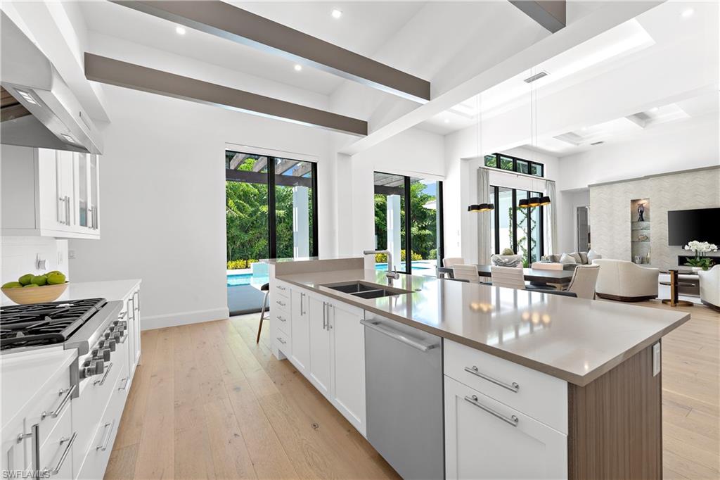 470 Wedge Drive Naples, FL 34103 - Photo 11 of 28 a kitchen with sink stove and cabinets
