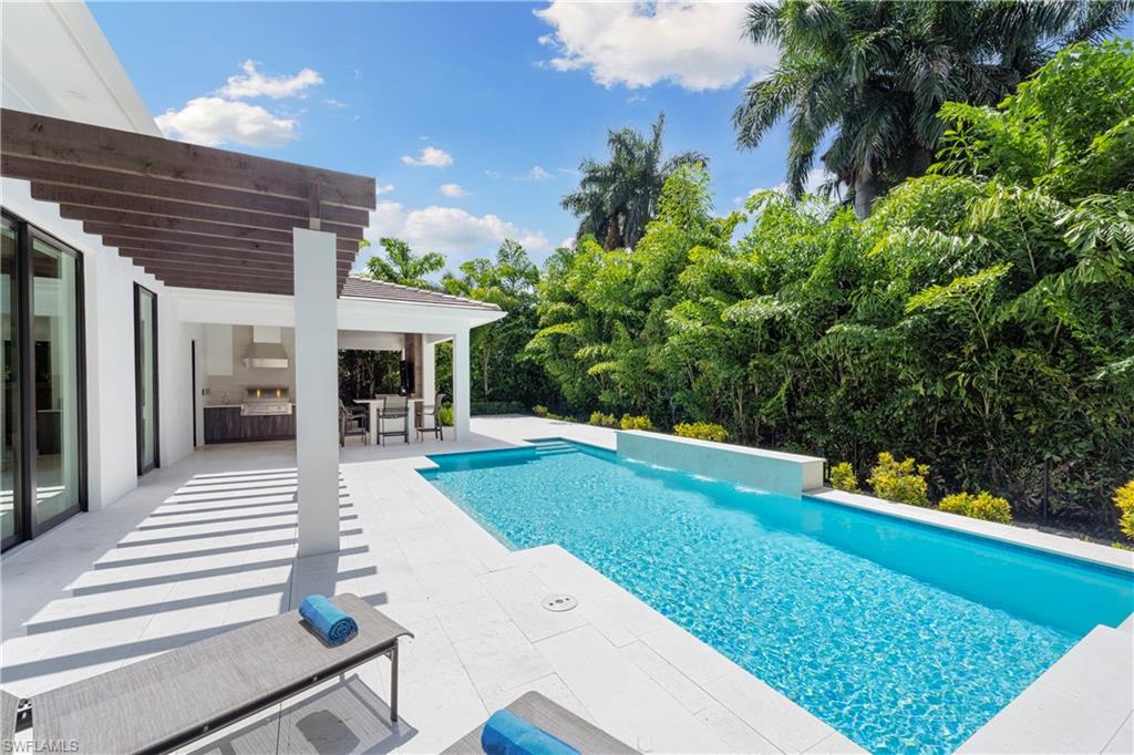 470 Wedge Drive Naples, FL 34103 - Photo 14 of 28 a view of a house with backyard porch and sitting area