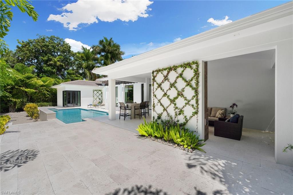470 Wedge Drive Naples, FL 34103 - Photo 15 of 28 a view of a house with backyard and sitting area