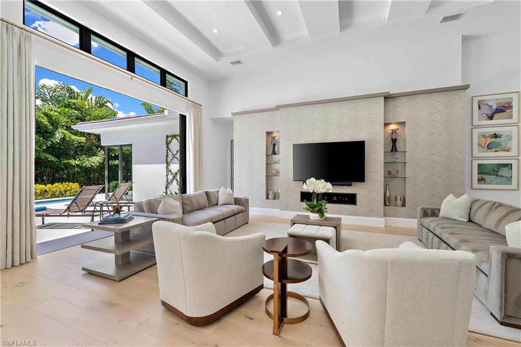470 Wedge Drive Naples, FL 34103 - Photo 16 of 28 a living room with furniture and a flat screen tv