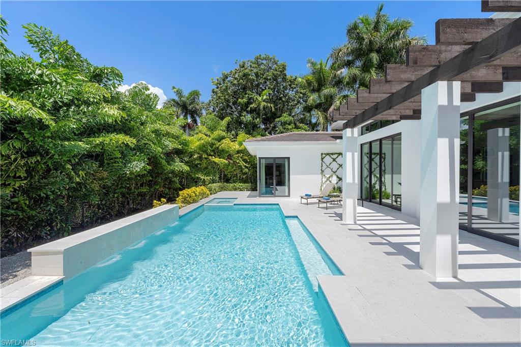 470 Wedge Drive Naples, FL 34103 - Photo 2 of 28 a view of a house with backyard and porch