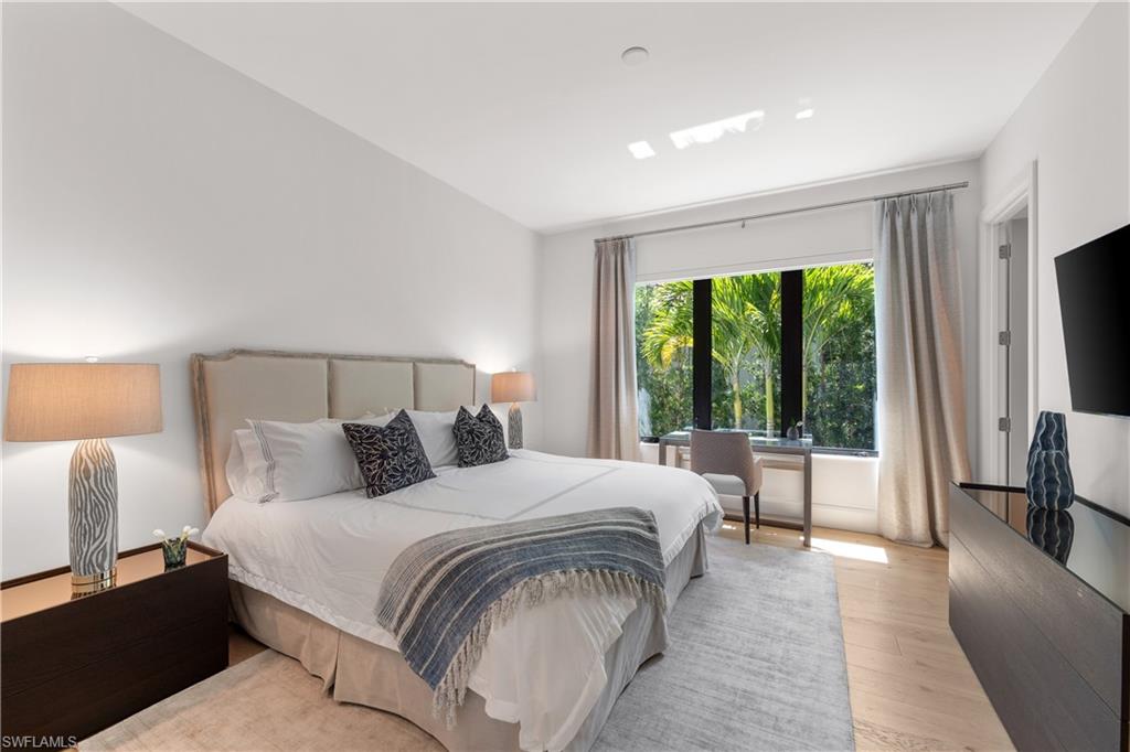 470 Wedge Drive Naples, FL 34103 - Photo 23 of 28 a bedroom with a large bed and a large window