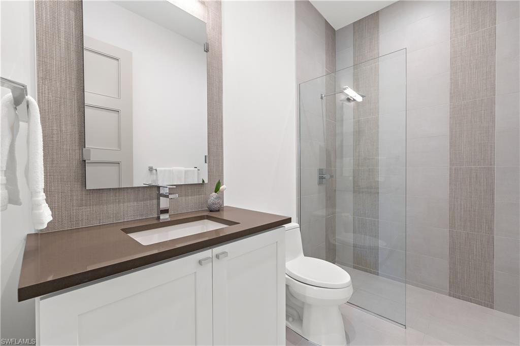 470 Wedge Drive Naples, FL 34103 - Photo 24 of 28 a bathroom with a sink a toilet and shower