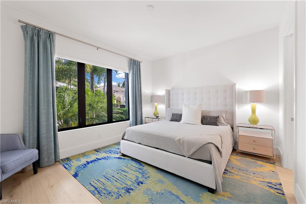 470 Wedge Drive Naples, FL 34103 - Photo 25 of 28 a bedroom with a bed and a large window